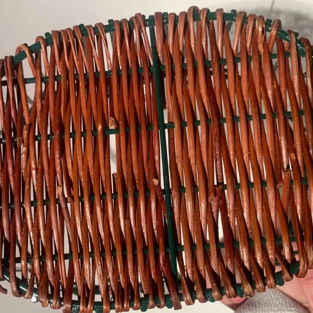 Green wire basket with brown woven bottom